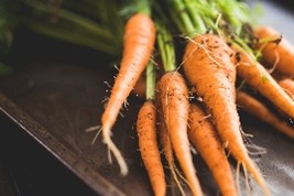 Clear photograph of carrots on wood table